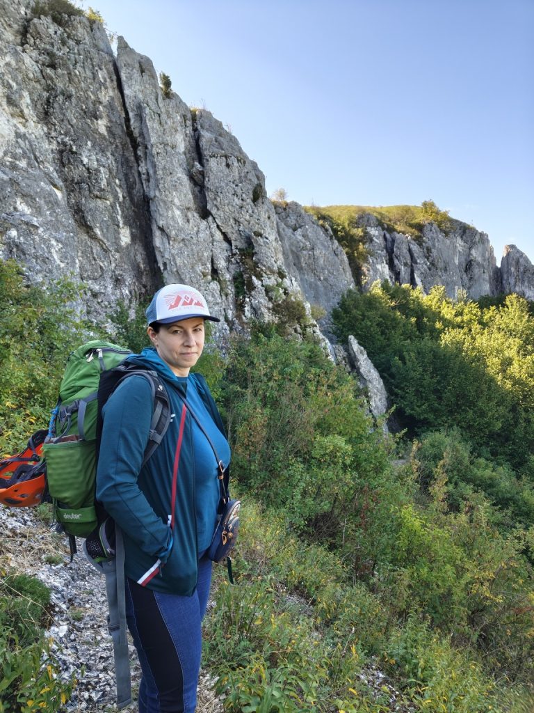 Kobieta stoina naścieżce pod Powroźnikową skałą na Jurze w Dolinie Racławki